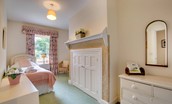 The Eslington Lodge - bedroom four with single bed and built in wardrobe and chest of drawers