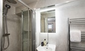 Harbour Hideaway - shower room containing shower with rainforest shower head and separate attachment