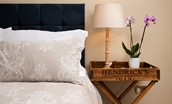 Goose Cottage - quirky gin-themed bedside tables in bedroom one