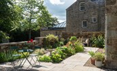 Birks Stable Cottage - pretty patio garden, ideal for enjoying a morning coffee at the bistro table
