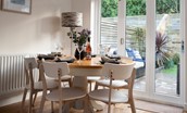 No. 6 - dining table situated in front of bi-folding doors offering views of the garden while guests enjoy their meals