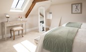 Brockmill Farmhouse - bedroom four on second floor with exposed beams, hanging space and dressing table