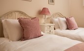 Kilham Cottage - twin beds in bedroom two with bedside table and lamp