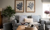 Greengate - comfortable sofas and costal themed artwork in the sitting room
