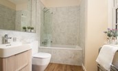 The Coach House, Kingston - family bathroom with bath and shower over, WC and basin