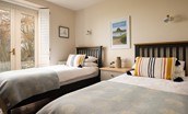 Castle View Cottage - bedroom two with twin beds and French doors leading to the rear garden