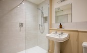 Wark Farmhouse - bedroom three en suite shower room with walk-in shower, WC and basin