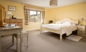 Bee Cottage - the master bedroom is comfortably appointed with crisp white linen and good storage space