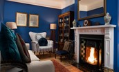 The Hermitage - painted in a striking ultramarine blue, the sitting room is dotted with select pieces from the owners' antique collection