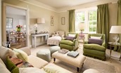 Lane Cottage - lounge area with a two-seater sofa, two armchairs, chaise and two pouffes