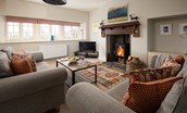 Farm Cottage - open plan sitting room with fireplace and wood burner facing the front garden