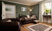 Brockmill Farmhouse - snug with leather Chesterfield style sofa and armchair