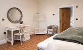 Granary View, Brockmill Farm - bedroom three on the ground floor with zip and link beds, dressing table and chair, occasional chair, bedside tables and storage space