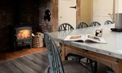 East House - kitchen with inglenook fireplace and a cosy wood burner