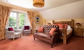 Dryburgh Farmhouse - bedroom two with large glazed doors with Juliet balcony offering views over the garden and river