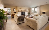 Goose Cottage - large sitting room with plush sofa suite centred around the wood burner