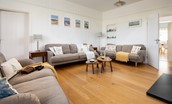 Driftwood Bamburgh - sitting room with two large sofas and one double sofa for guests to relax on