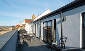 Seaside House - large balcony to the rear of the property with outdoor furniture and barbecue to enjoy alfresco dining