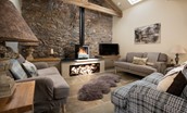 The Old Byre at West Moneylaws - the living area features flagstone floors and a woodburning stove