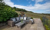 Bay View Cottage - the stone flagged patio with generous sofa seating