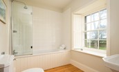 The Old Vicarage - en-suite bathroom containing shower over bath, WC and basin