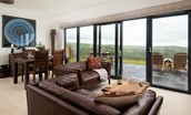 The Maple - open plan living and dining area with bi-fold doors leading onto the patio area