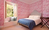 Honeystone House - bedroom one with king size bed and charming window seat