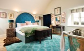 Lakeside Cottage - Emily - a vibrant blue arched headboard hangs above the sumptuous super king bed
