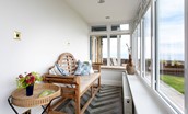 Sea Breeze - bench seating in the sun room where you can enjoy coastal views