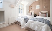 Marine House Cottage - bedroom two with fixed twin beds and bedside tables