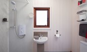 Foxglove - bathroom with electric shower, WC and basin