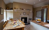 The Boathouse - the kitchen with table seating up to eight guests