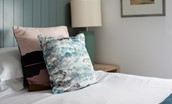 Red Herring - stylish touches in bedroom two including tongue and groove panelling and coastal artwork