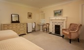 Mossfennan House - bedroom five with twin beds and decorative fireplace