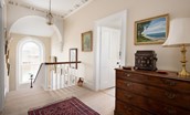 The Old Manse - upstairs landing with central staircase and feature arched window
