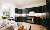 Cairnbank House - the kitchen with painted cabinets in Farrow & Ball studio green is an informal space for breakfasts and lunches