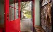 Walltown Farm Cottage - entrance porch with coat rack and bench seating with shoe storage