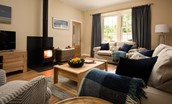 The Coach House, Kingston - cosy sitting room with wood burning stove