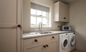 Risingham Cottage - utility room with washing machine and tumble dryer