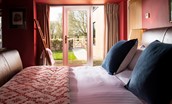 Lakeside Cottage - Edward - the glass door in the bedroom opens out to the enclosed garden