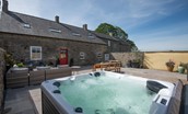 Fell End - hot tub in the sheltered courtyard to the rear of the property