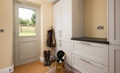 Shepherd's House - utility room with sink, washer/dryer, bench seat and hanging rail