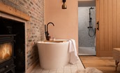 East Lodge Home Farm - free-standing bath in bedroom one with cosy log burner