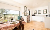 Lakeside Cottage - Edward - the open-plan kitchen and dining space benefits from a large corner window allowing light to beam in