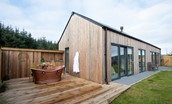 The Maple - direct access from the bathroom out to the decking area with copper Shaanti bath