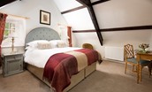 East End Cottage - bedroom one with King size bed and tweed headboard