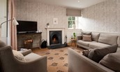 Garden House - sitting room with large corner sofa, open fire, dual aspect views and TV