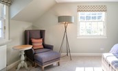 Blackhouse Forest Estate - soft occasional chair and footstool with lamp in bedroom five