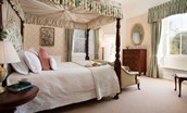 The Tower, Keith Marischal - bedroom one with four-poster canopy bed, antique mahogany furniture and window seat to admire the private grounds
