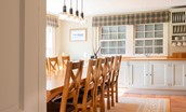 Blackhouse Forest Estate - large wooden dining table in the kitchen with views out to the garden